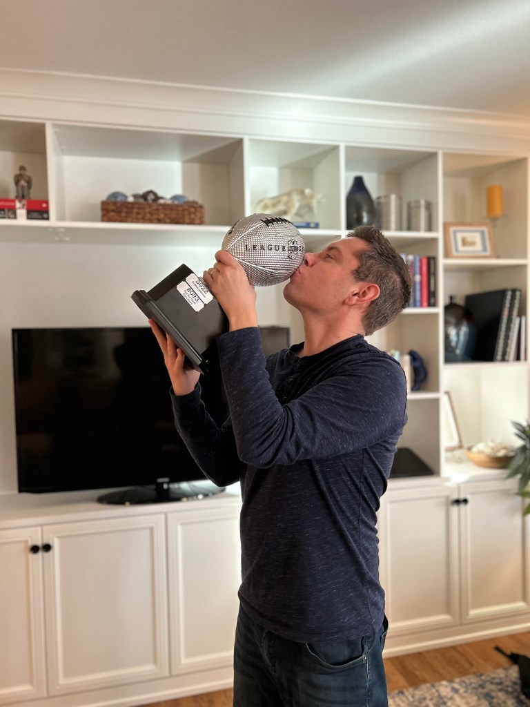 A picture of Chris Barry of Chris Barry Voiceover holding a fantasy football trophy.